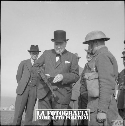 WINSTON CHURCHILL AS PRIME MINISTER 1940-45 (H 2646) Winston Churchill inspects a 'tommy gun' during an inspection of invasion defences near Hartlepool, 31 July 1940. Copyright: © IWM. Original Source: http://www.iwm.org.uk/collections/item/object/205197236